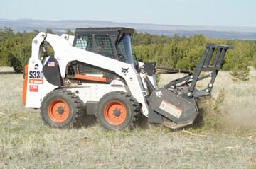 Bobcat S330 with forest head attachment (Fecon type)